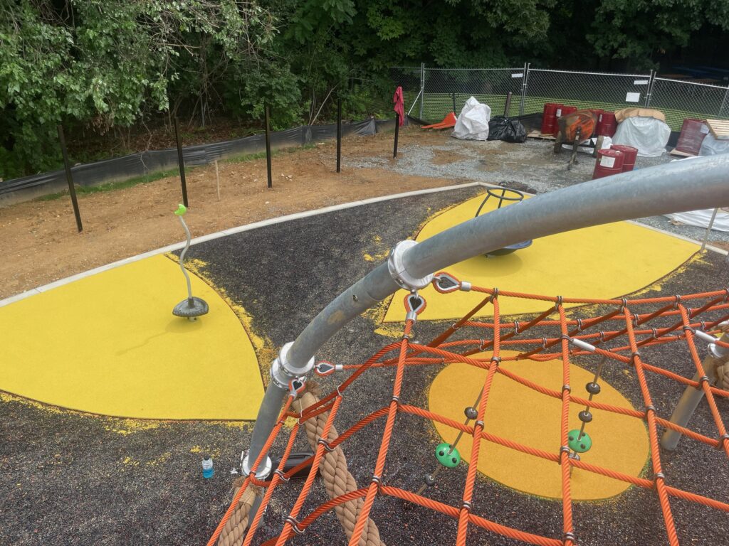 Custom Park Surfacing / HRGM photo of the smaller poured rubber colored areas from the top of the climbing structure. This is after the rubber base has been installed but before the final, larger colored rubber area is installed at the Anne Beers Elementary School playground in Washington, D.C.