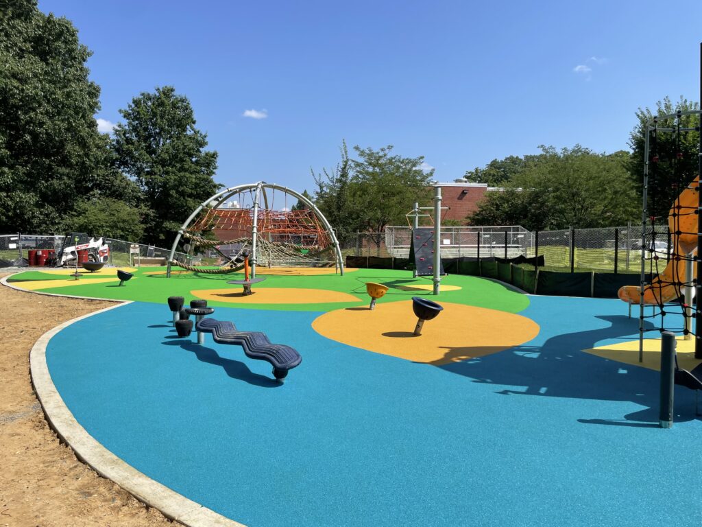 Custom Park Surfacing - Anne Beers playground, smaller and larger areas of colored poured rubber image.